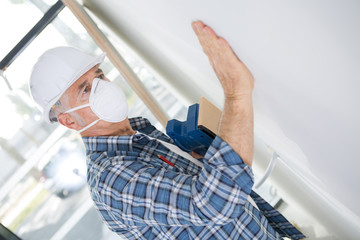 man stroking plaster to give it a finished look