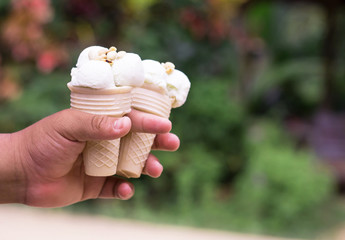 man hands holding ice cream cones on summer