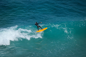 Aerial view of a surfer on a wave