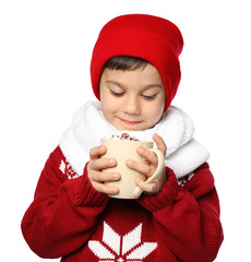 Cute little boy in warm clothes and with cup of hot cocoa drink on white background