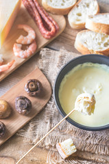 Fototapeta na wymiar Bowl of fondue with appetizers