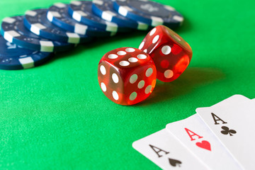Dice, poker chips and playing cards on the green table . Game concept. Games of chance