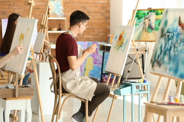 Male student during during classes in school of painters