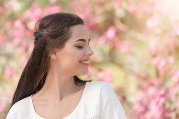 Fototapeta premium Beautiful young woman in park on spring day