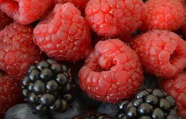 Fruits of ripe raspberries, blackberries.