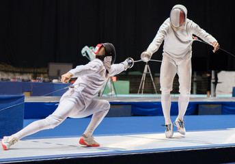 Two man fencing athletes fight