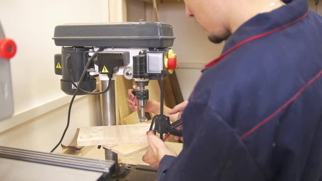 Joiner teaches his little son to woodworking in workshop
