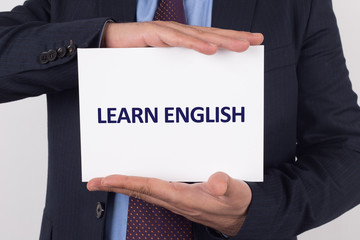 Man showing paper with LEARN ENGLISH text