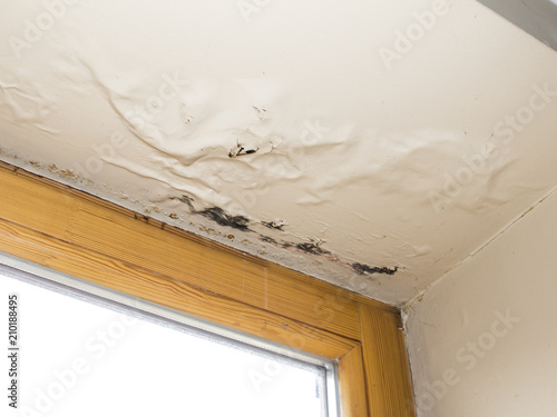 Water Damaged Ceiling Next To Window Stock Photo And