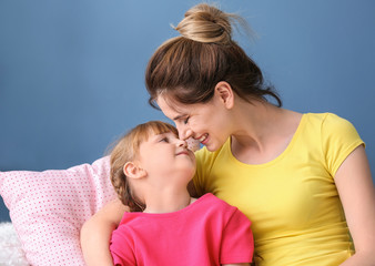 Fototapeta premium Mother and her daughter resting together at home