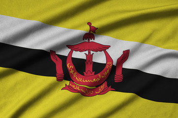 Brunei Darussalam flag  is depicted on a sports cloth fabric with many folds. Sport team banner