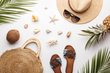Summer composition. Fruits, hat, tropical palm leaves, seashells on white background. Flat lay, top...