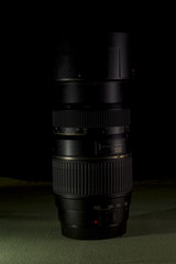 Obraz na płótnie Canvas Photographer black DSLR telephoto lens. Dark photo.