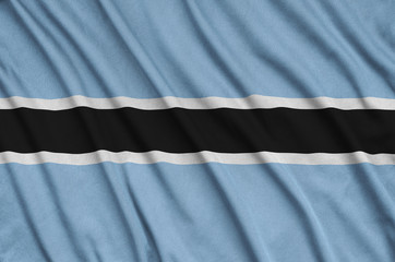 Botswana flag  is depicted on a sports cloth fabric with many folds. Sport team banner