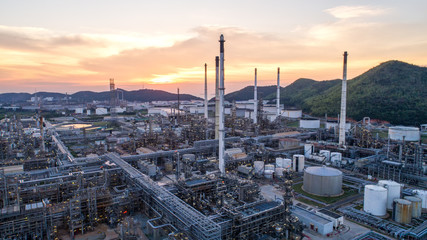 Industrial view at oil refinery plant form industry zone with sunrise and cloudy sky.Oil refinery and Petrochemical plant at dusk,Thailand. Aerial view