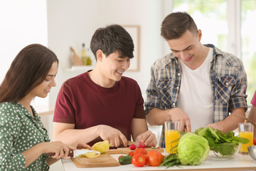Friends cooking together in kitchen
