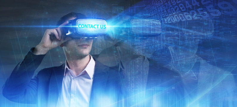 Business, Technology, Internet and network concept. Young businessman working in virtual reality glasses sees the inscription: Contact us