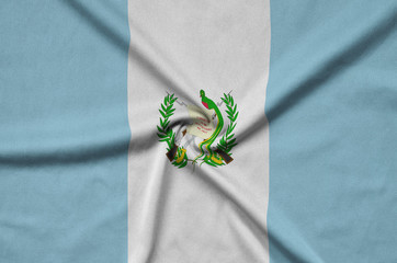 Guatemala flag  is depicted on a sports cloth fabric with many folds. Sport team banner