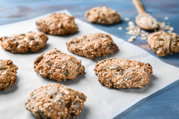 Delicious oatmeal cookies on color table