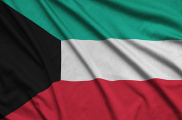 Kuwait flag  is depicted on a sports cloth fabric with many folds. Sport team banner