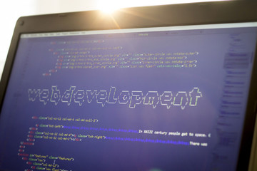 Web development phrase ASCII art inside real HTML code. Web developing concept on screen. Abstract information technology modern background. Digital art. Code is created by myself.