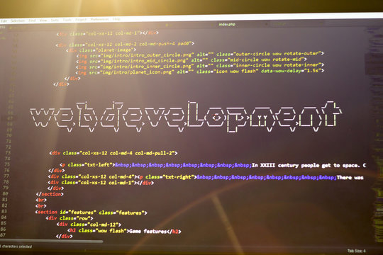Web development phrase ASCII art inside real HTML code. Web developing concept on screen. Abstract information technology modern background. Digital art. Code is created by myself.
