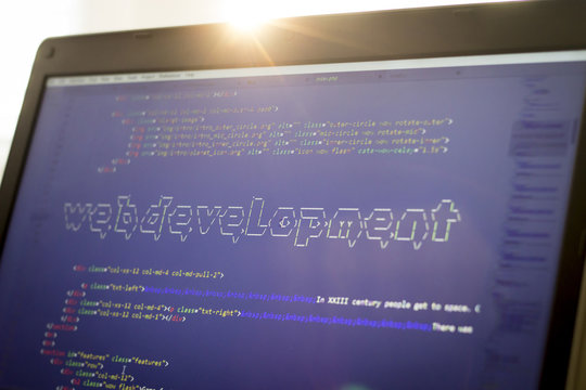 Web development phrase ASCII art inside real HTML code. Web developing concept on screen. Abstract information technology modern background. Digital art. Code is created by myself.