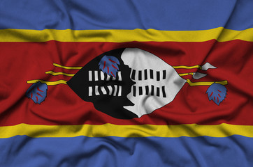 Swaziland flag  is depicted on a sports cloth fabric with many folds. Sport team banner