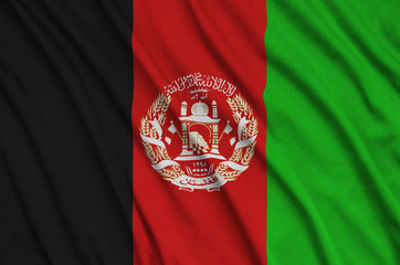 Afghanistan flag is depicted on a sports cloth fabric with many folds. Sport team banner