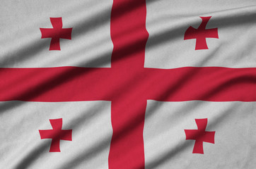 Georgia flag  is depicted on a sports cloth fabric with many folds. Sport team banner