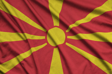 Macedonia flag  is depicted on a sports cloth fabric with many folds. Sport team banner
