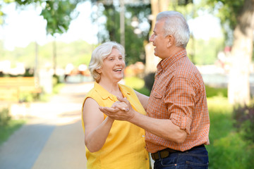 Happy mature couple dancing outdoors