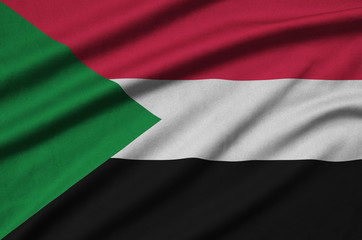 Sudan flag  is depicted on a sports cloth fabric with many folds. Sport team banner