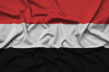 Yemen flag  is depicted on a sports cloth fabric with many folds. Sport team banner