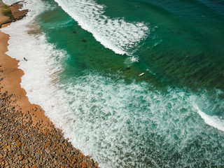 surfer on the beach top view. Drone shot on a beach in a summer day.