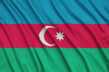 Azerbaijan flag  is depicted on a sports cloth fabric with many folds. Sport team banner