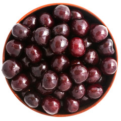 Fresh cherry in a bowl isolated on white background. Top view