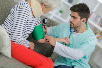 elderly lady having blood pressure checked