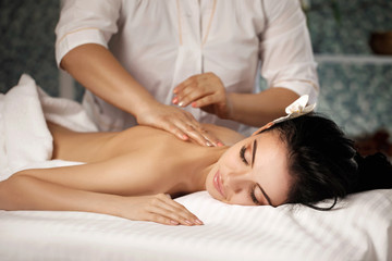 Obraz na płótnie Canvas Relaxed woman receiving massage
