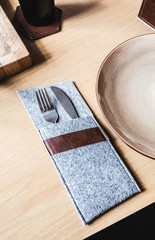 Cutlery socket and a salad on a wooden table