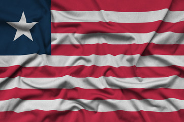 Liberia flag  is depicted on a sports cloth fabric with many folds. Sport team banner
