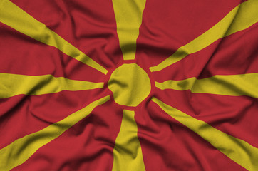Macedonia flag  is depicted on a sports cloth fabric with many folds. Sport team banner