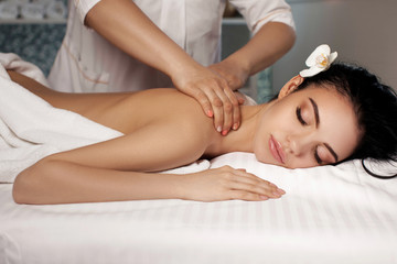 Relaxed woman receiving massage