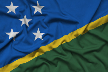 Solomon Islands flag  is depicted on a sports cloth fabric with many folds. Sport team banner