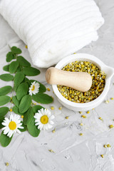 Dried chamomile flowers, natural ingredients for homemade body, face salt scrub, mask, SPA concept