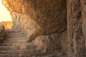 Stone staircase in the rock, toned