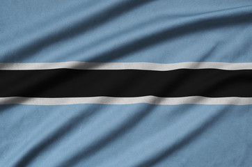 Botswana flag  is depicted on a sports cloth fabric with many folds. Sport team banner