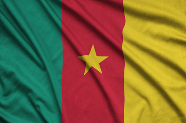Cameroon flag  is depicted on a sports cloth fabric with many folds. Sport team banner