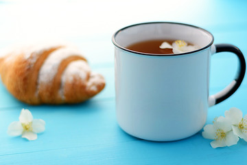 
Jasmine tea with jasmine herb flower on wooden table background. 