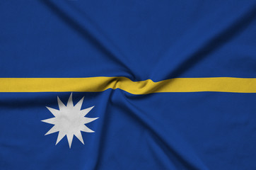 Nauru flag  is depicted on a sports cloth fabric with many folds. Sport team banner